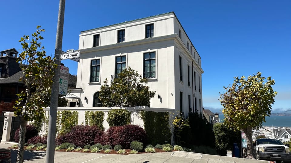A brick warehouse with a large arched window in Hayes Valley, now occupied by a car showroom.