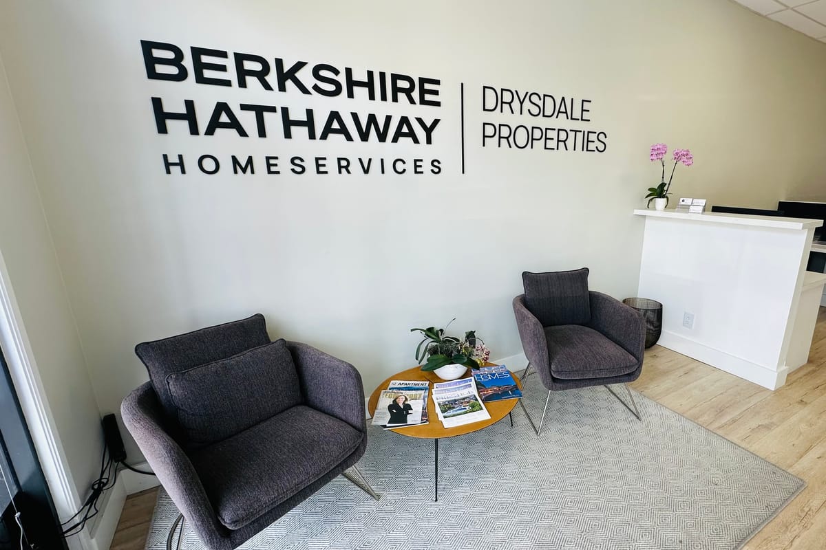 The reception area of Berkshire Hathaway HomeServices Drysdale Properties at 2425 California Street, San Francisco, with the brokerage lettering on the wall.